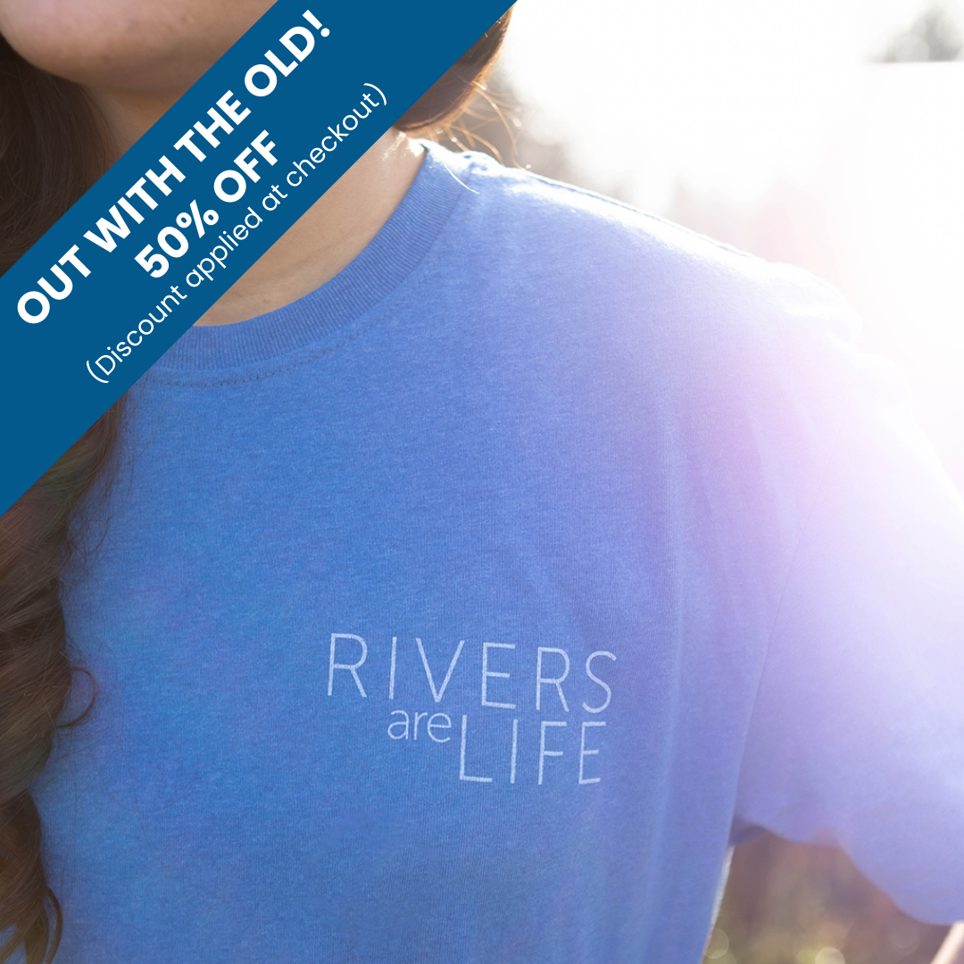 Person wearing a blue t-shirt with 'Rivers are Life' text.